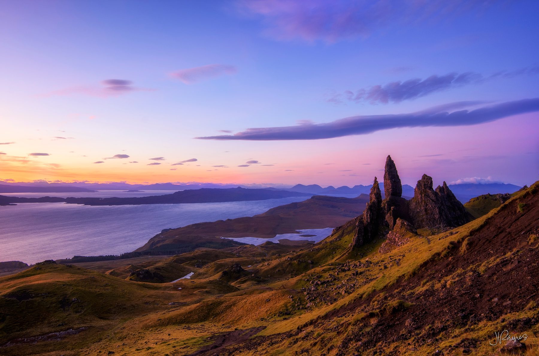 First light over the Isle of Skye, Scotland, with the Old Man of Storr standing on the ridge above the loch