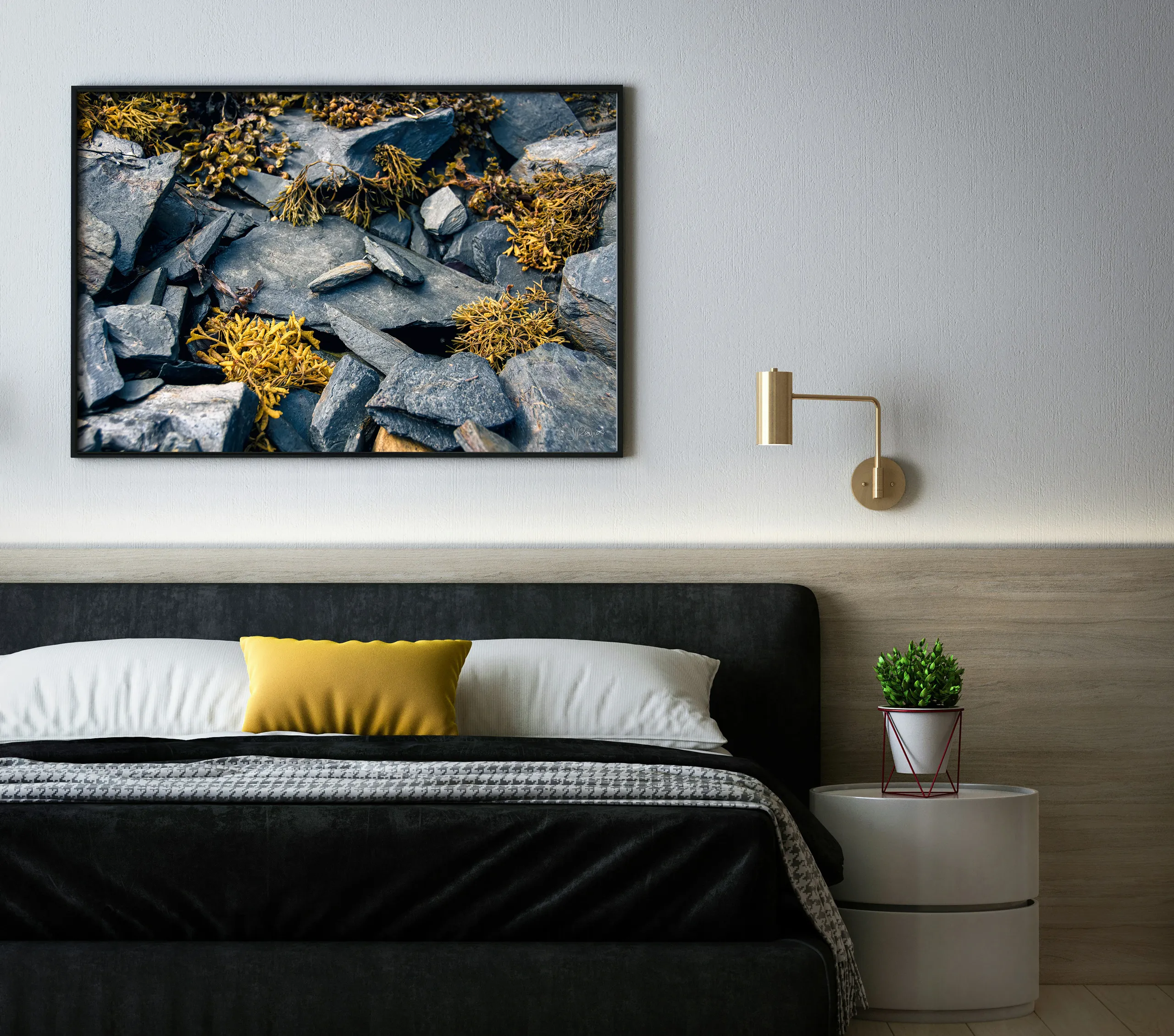 Golden Flotsam, a print of rocks and seaweed, hung above a bed