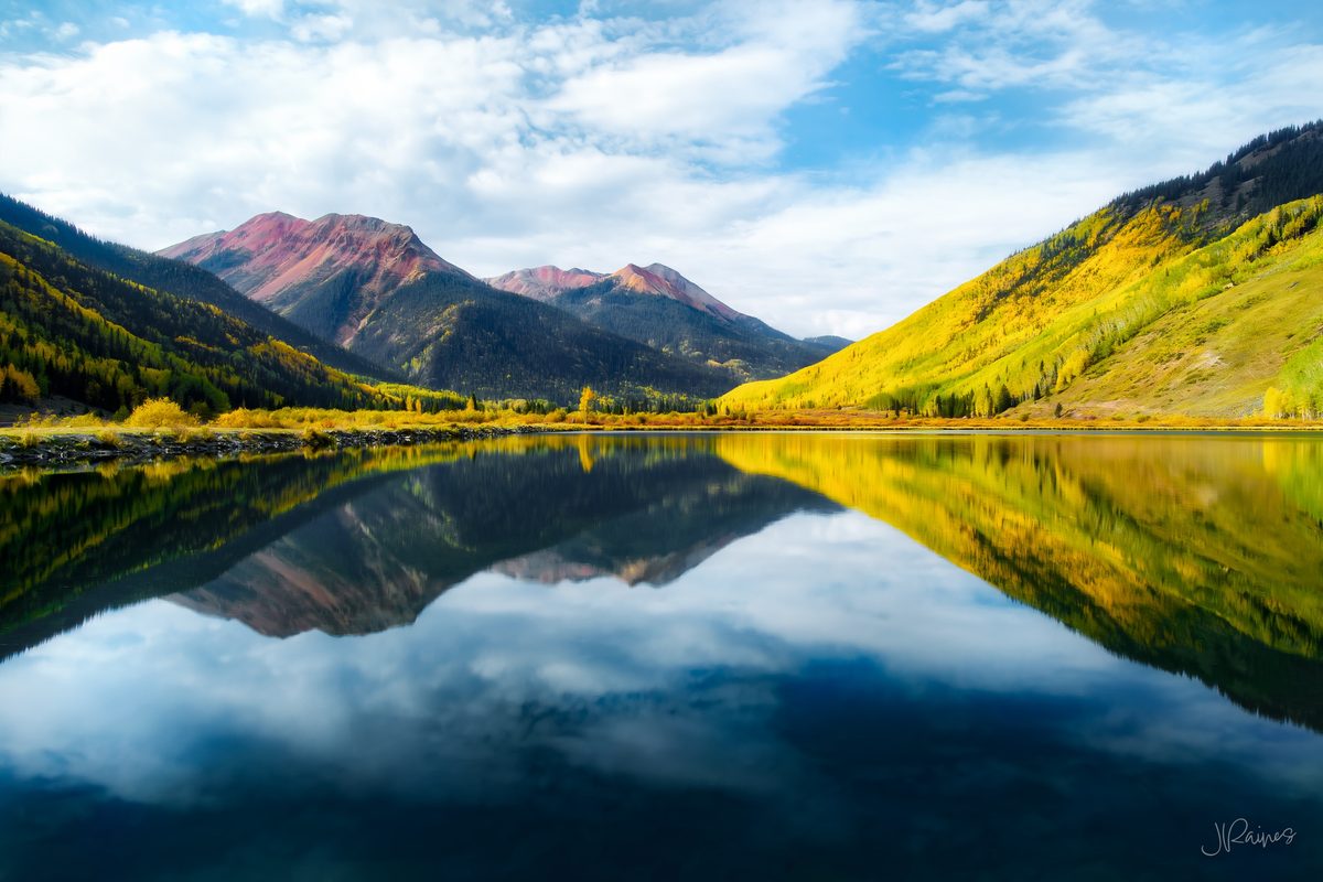 Red Mountain reflected in Crystal Lake beneath autumn aspens, Ouray, Colorado