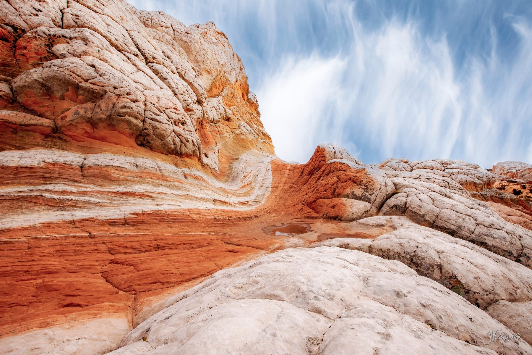 Banded sandstone at Vermilion Cliffs, Arizona, where iron in the rock lays down bands of red and cream in the same formation