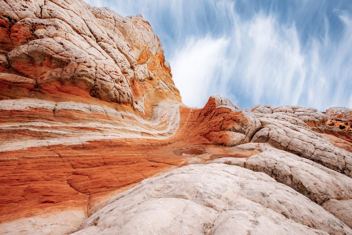 Banded sandstone at Vermilion Cliffs, Arizona, where iron in the rock lays down bands of red and cream in the same formation