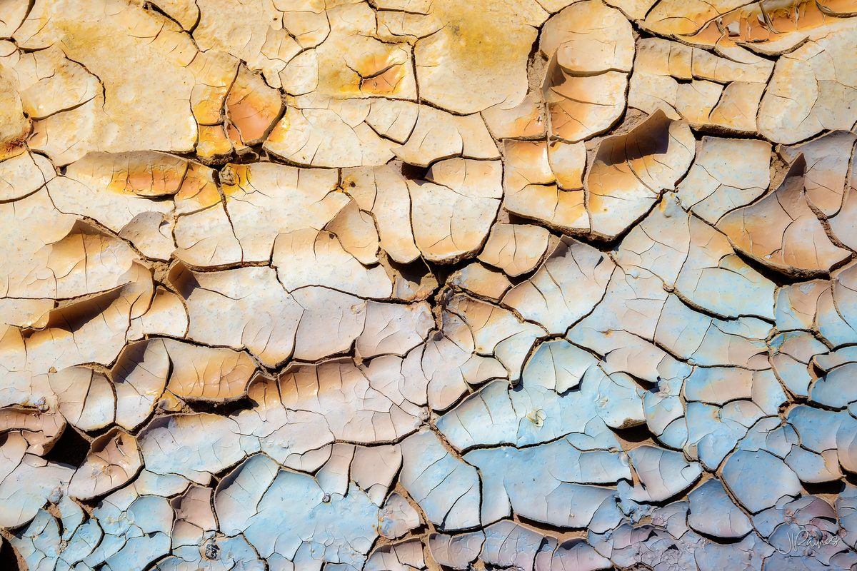 Cracked and flaking clay at Cathedral Gorge State Park, Nevada, the surface breaking into plates as it dries