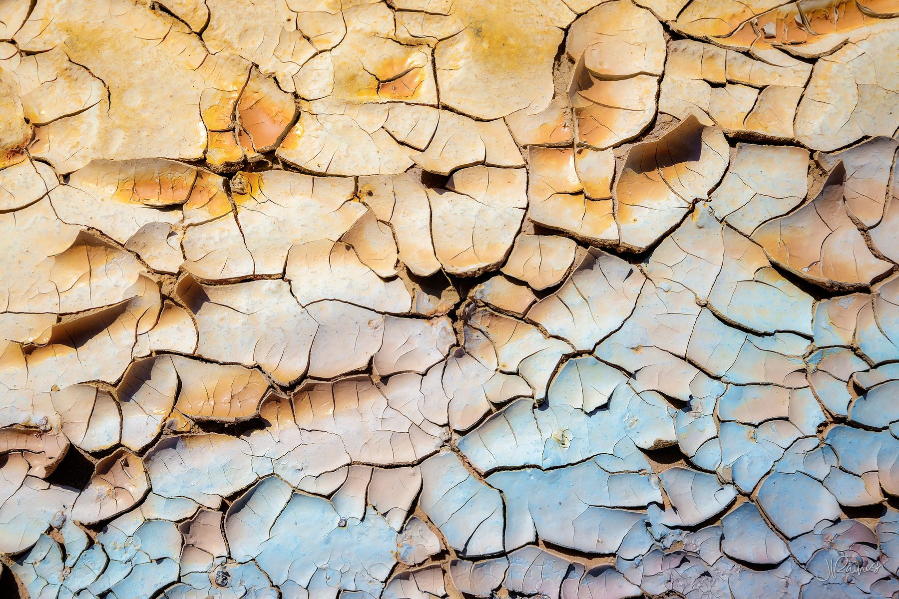 Cracked and flaking clay at Cathedral Gorge State Park, Nevada, the surface breaking into plates as it dries