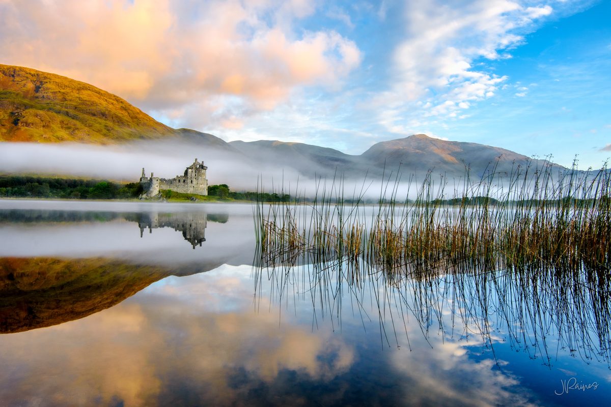 Kilchurn Castle at sunrise with lake reflections and fog, Argyll and Bute, Scotland