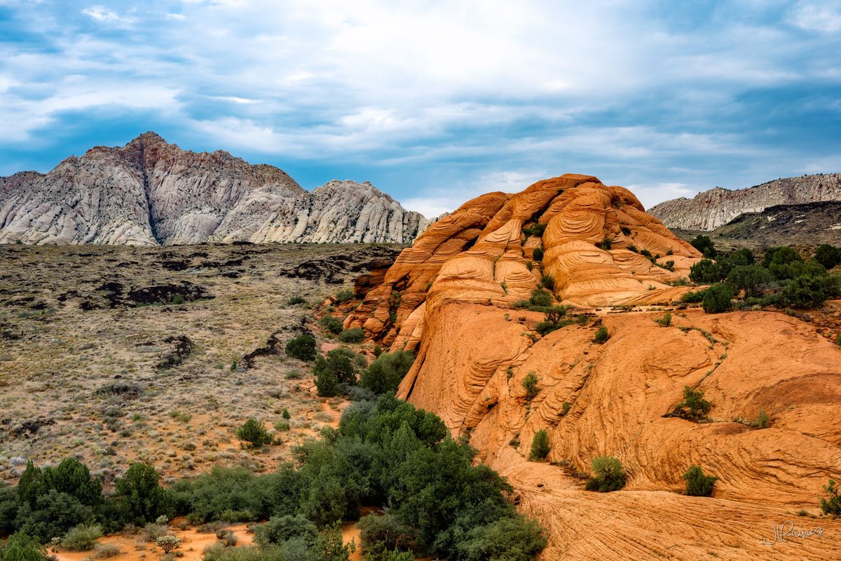 Striped sandstone and lava rock formations in Snow Canyon, Utah