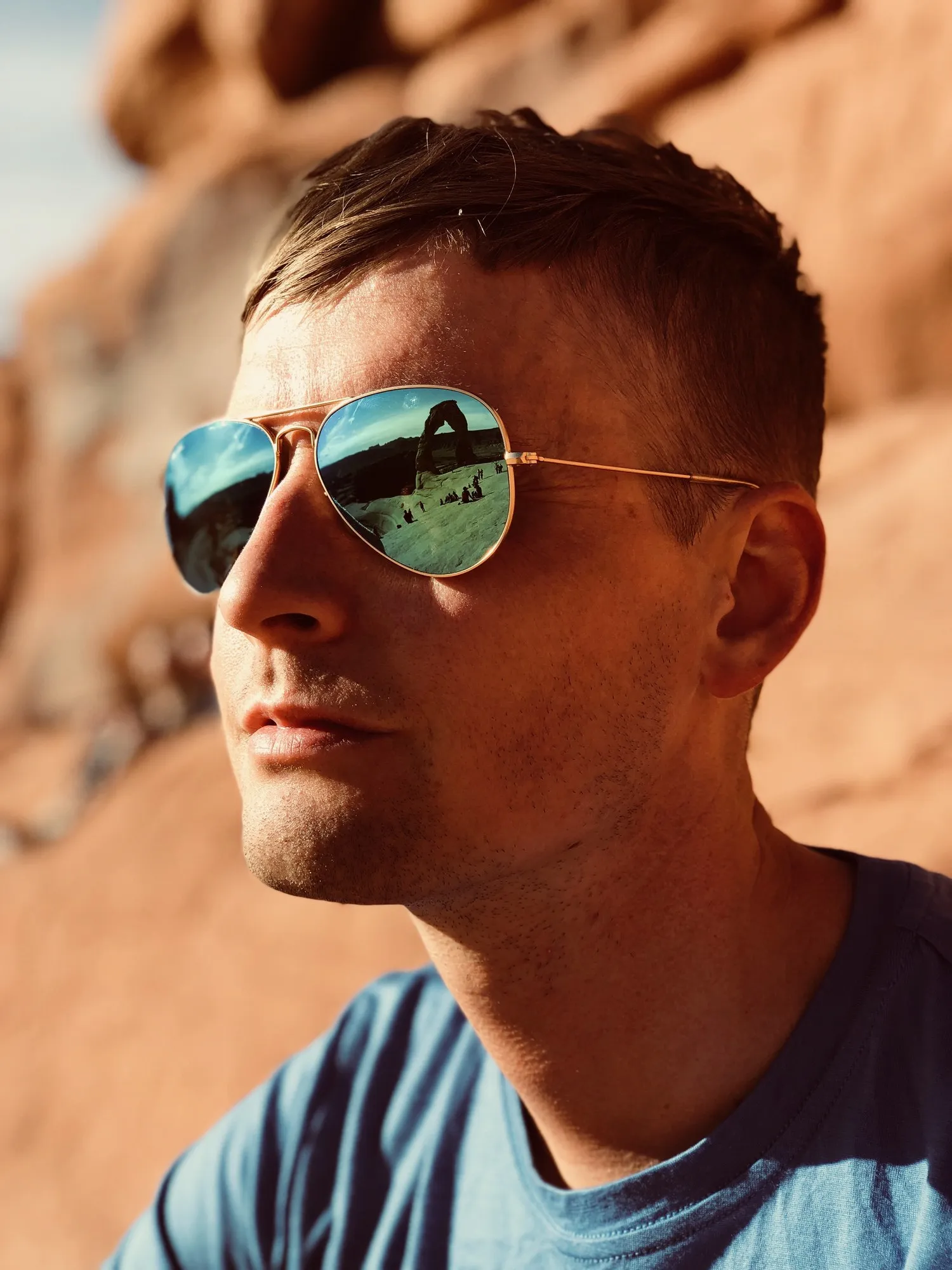 Jerad Raines at Arches National Park, Delicate Arch reflected in his sunglasses