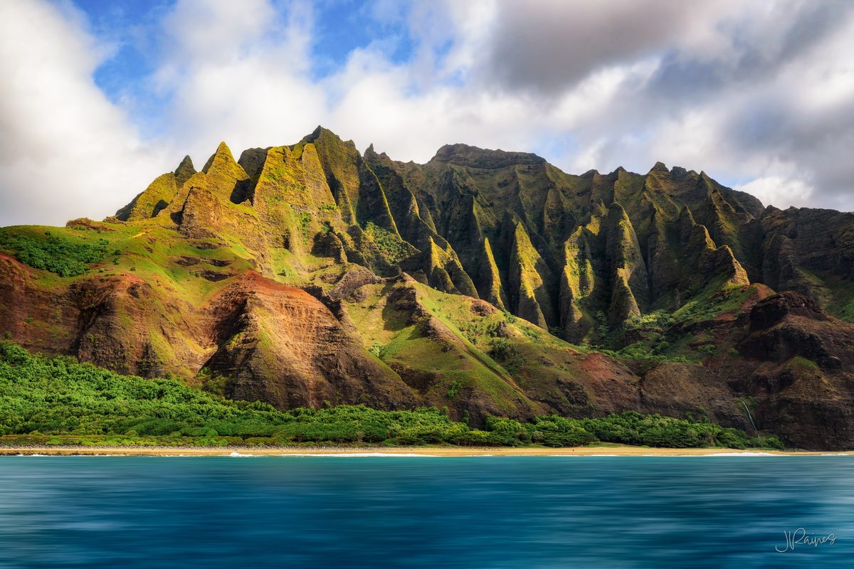 The green cliffs of Kauai, Hawaii, rising out of the water — the kind of terrain that has stood in for prehistory in more than one film
