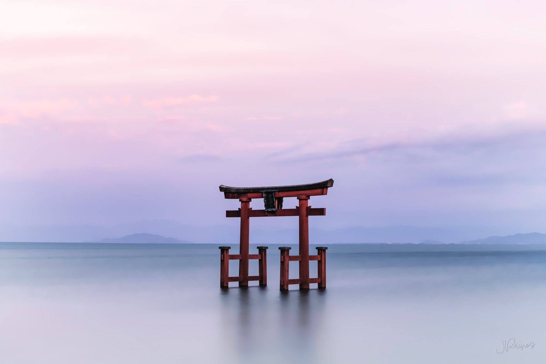 Torii gate in the late at dusk with smooth water, Takashima, Japan