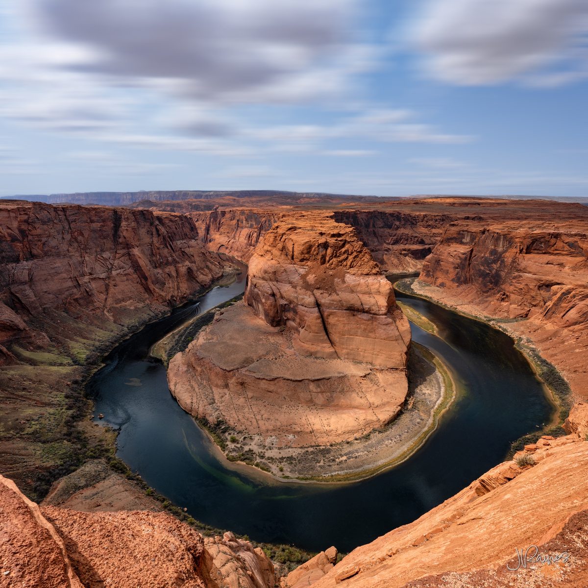 Horseshoe Bend near Page, Arizona, where the Colorado River wraps a full turn around a sandstone island a thousand feet below the rim