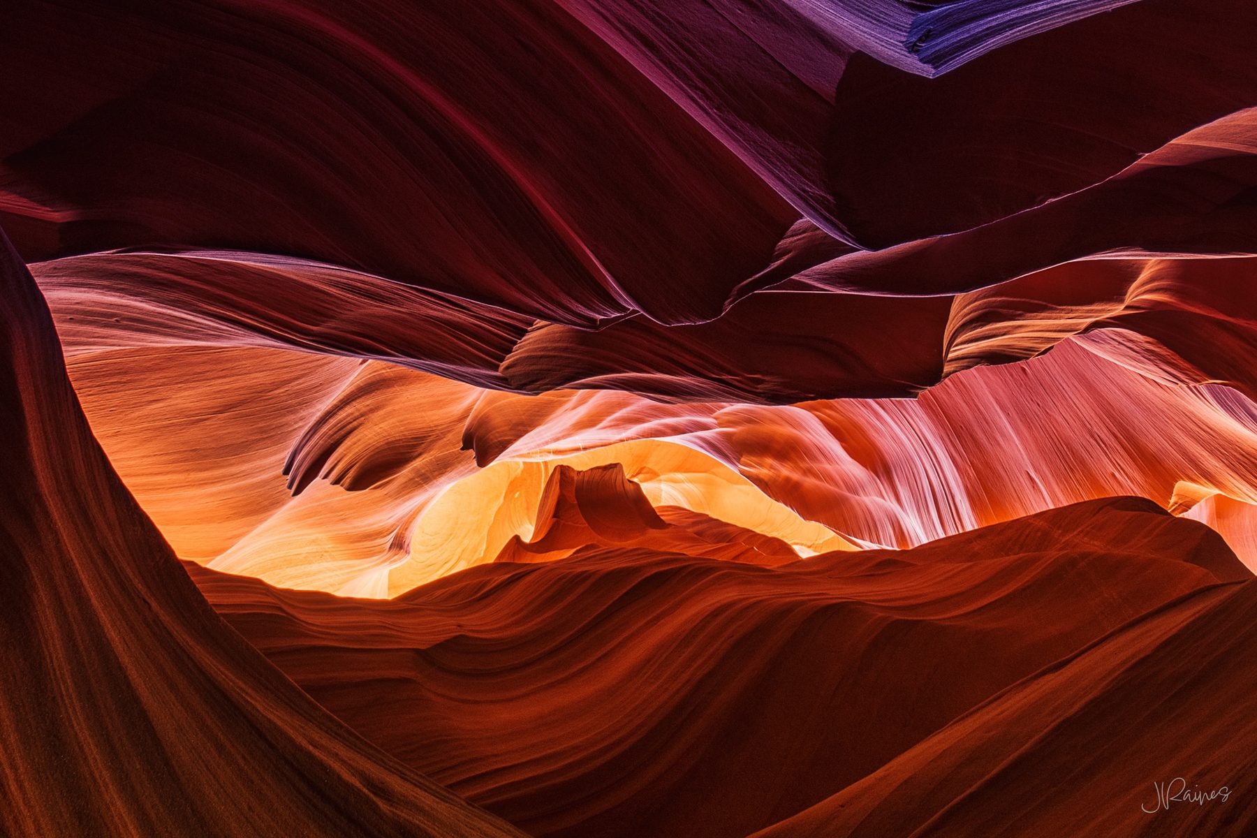 Looking upwards in a colorful, narrow slot canyon of Arizona