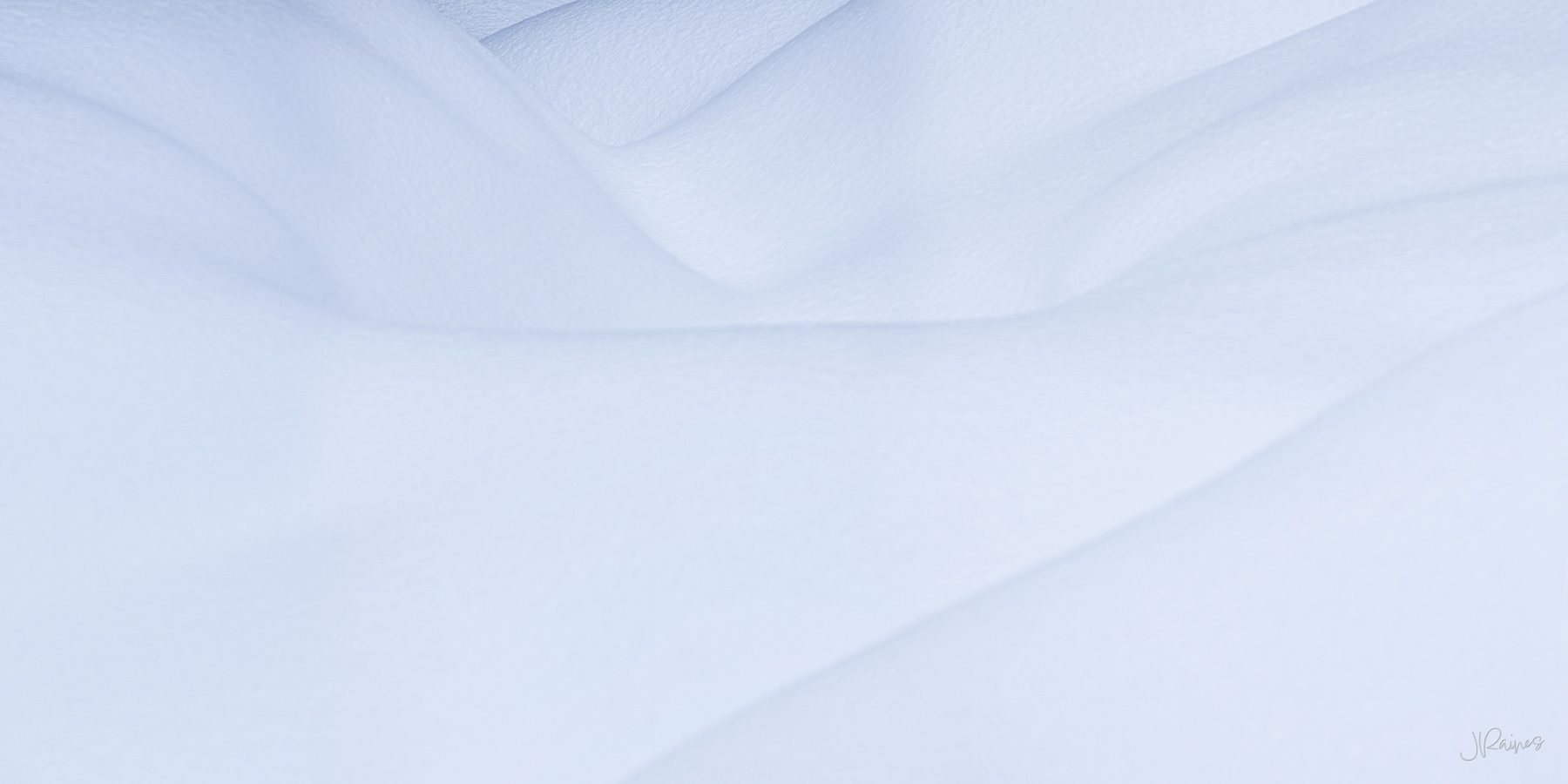 Wind-smoothed snow drifts over rolling terrain forming soft cloud-like volumes in pale blue-white, Grand Teton National Park, Wyoming