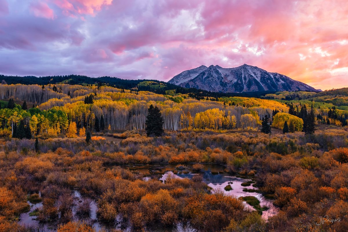 Autumn color stacked across the valley near Crested Butte, Colorado, with snow already on the high peaks behind