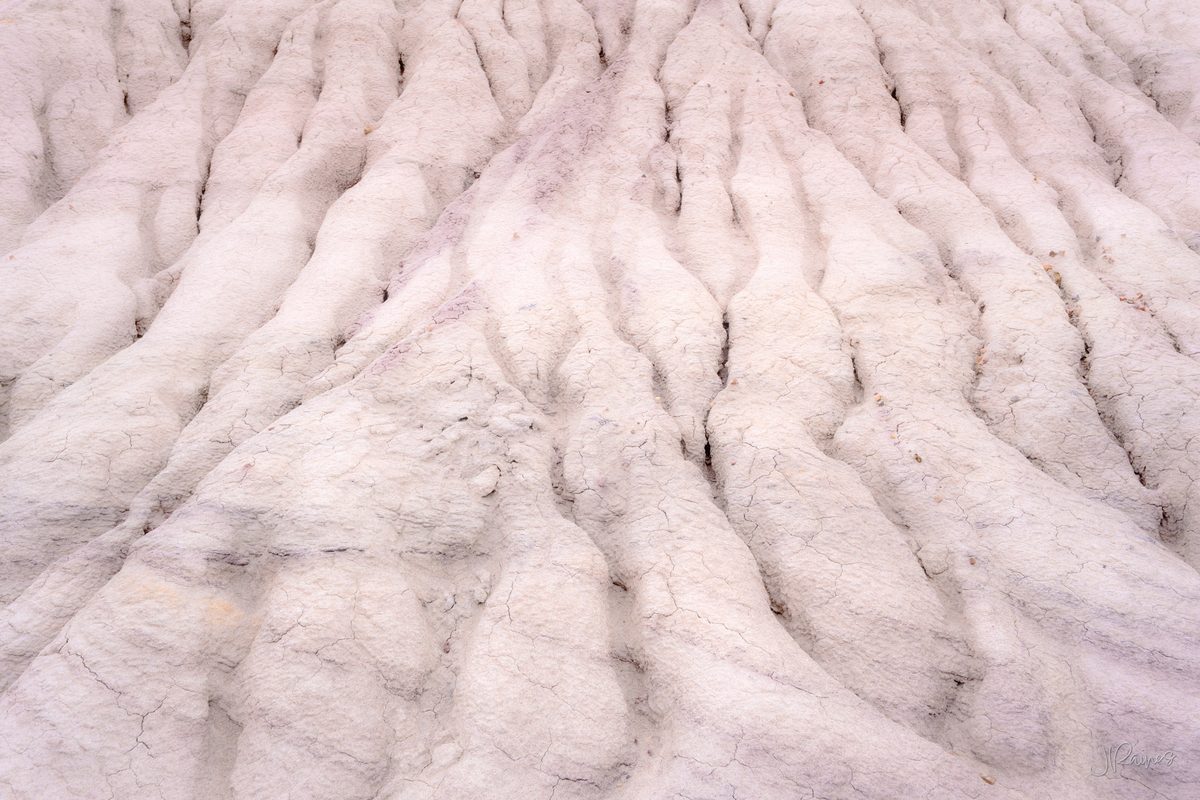 Pale eroded clay badlands ridged by runoff, Petrified Forest National Park, Arizona