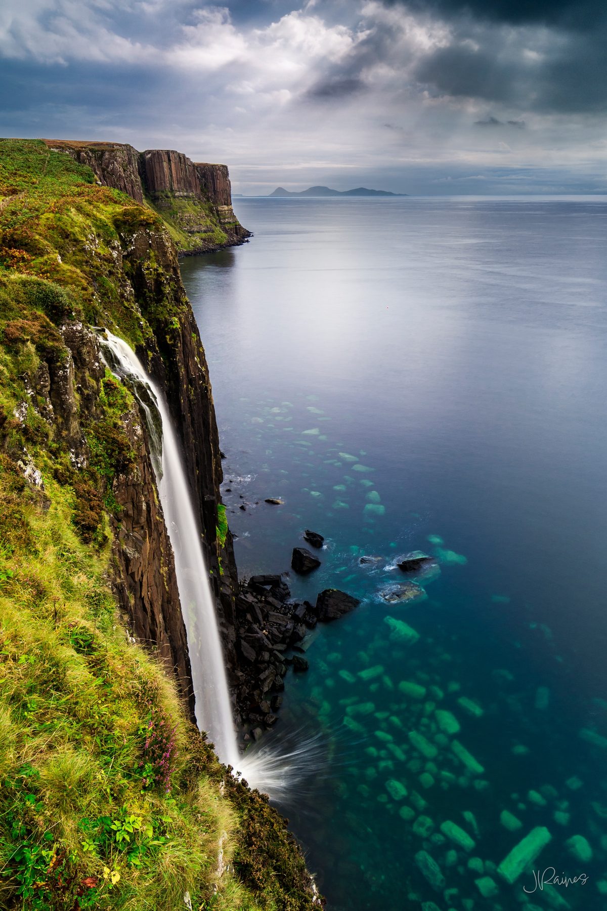 Waterfall on the coast of Scotland dropping into the sea