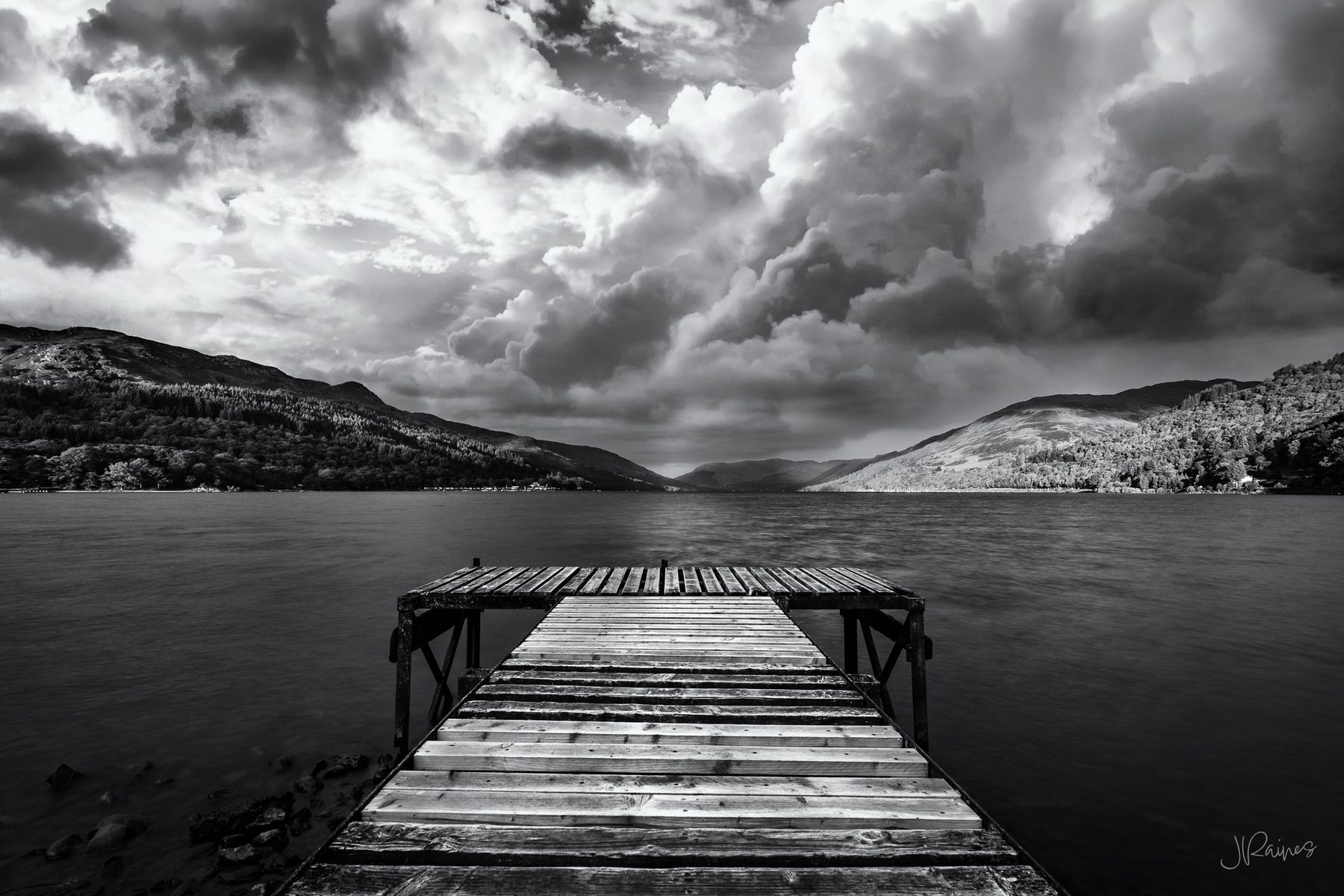 Pier at Loch Earn looking out at the water with storm clouds, Southern Highlands, Scotland