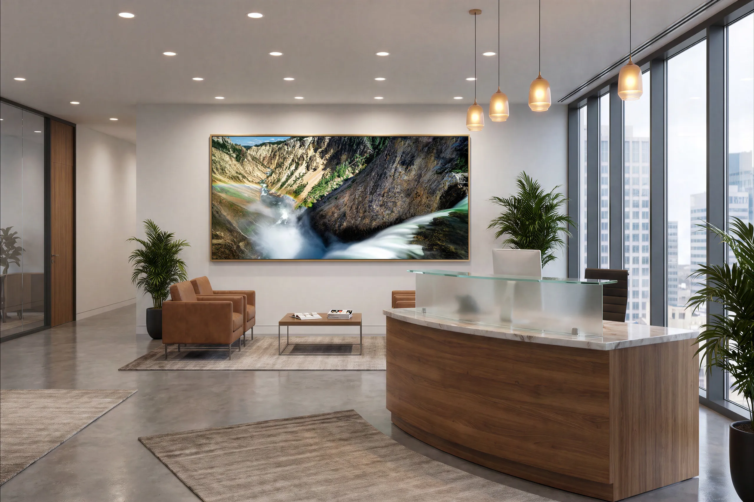 Swan Dive, a canyon waterfall panorama in a gold frame, visualized on the wall of a corporate reception area