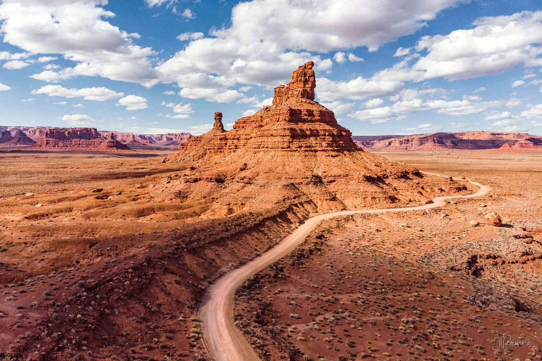 A sandstone formation in southeast Utah standing alone against the sky